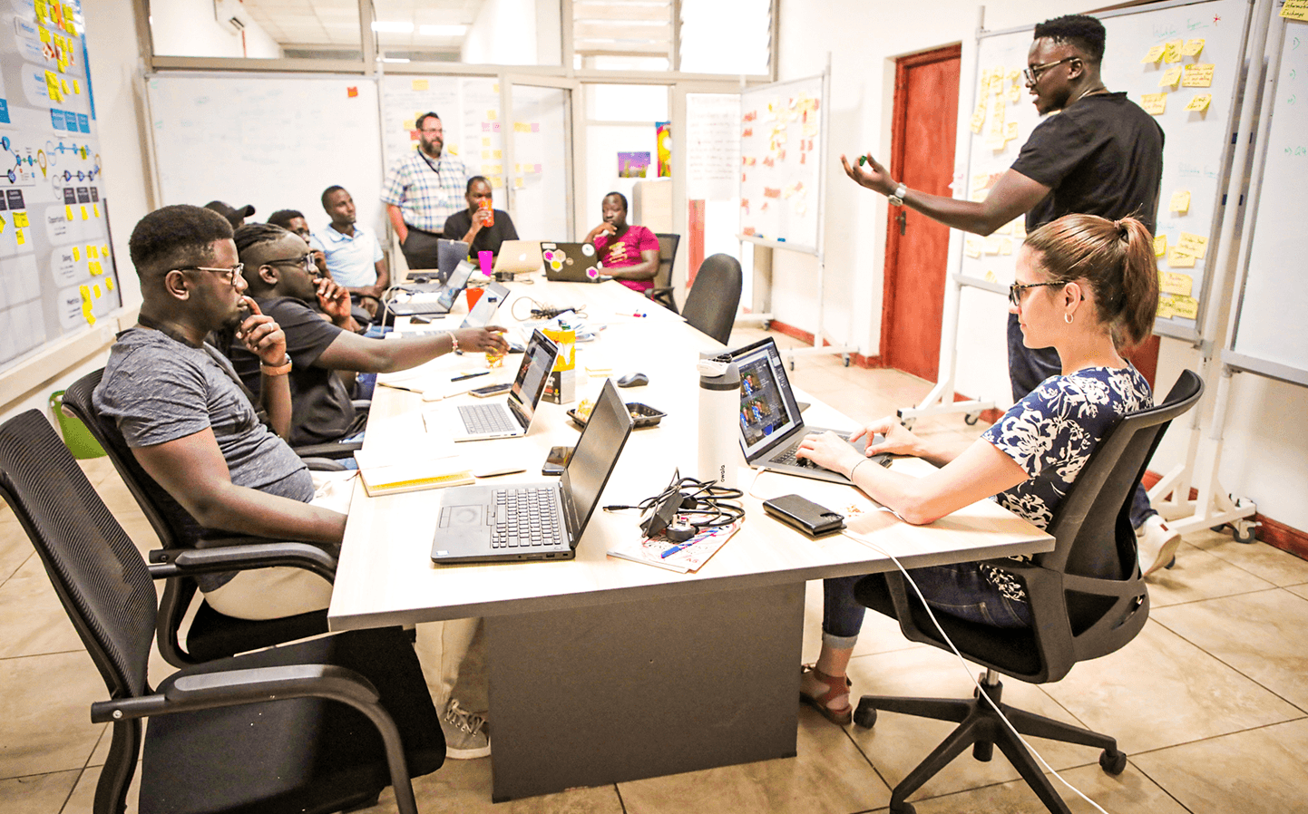 People in a planning meeting with one doing a presentation